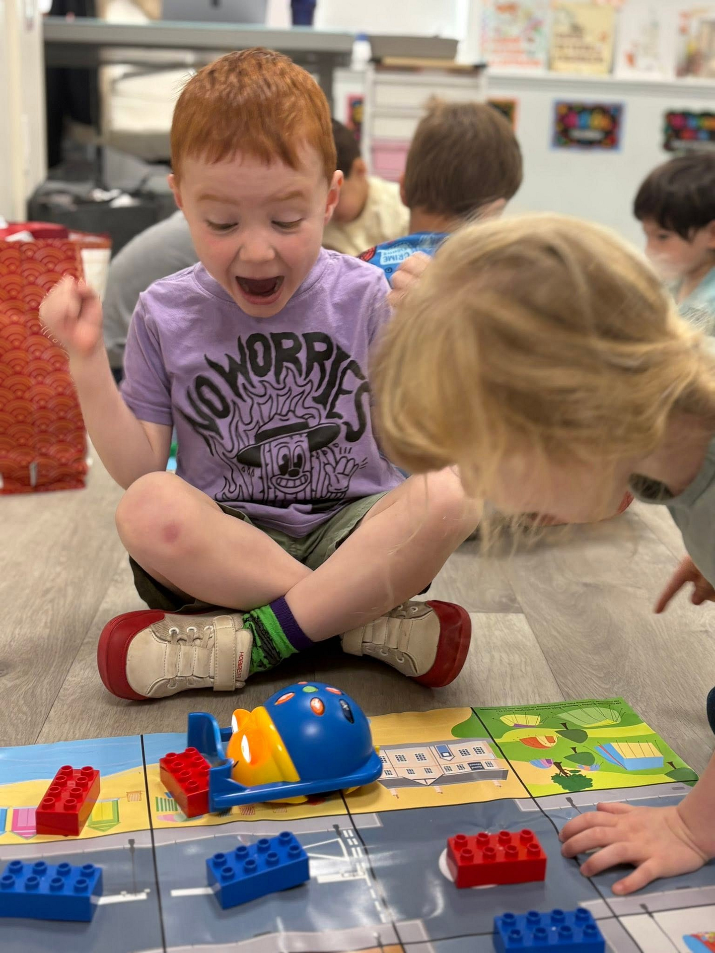 Bedford Academy student coding with a Bee-Bot robot
