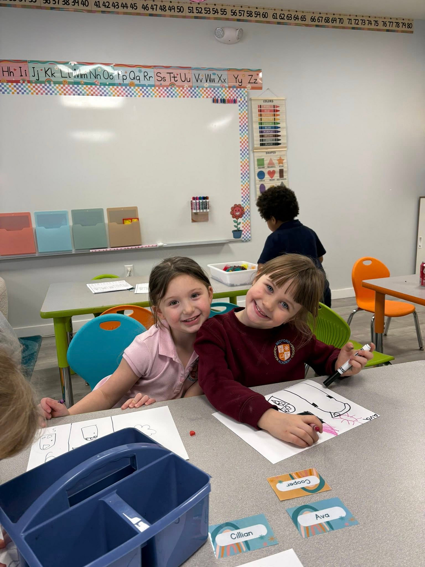 Lower School students smiling during a classroom learning activity